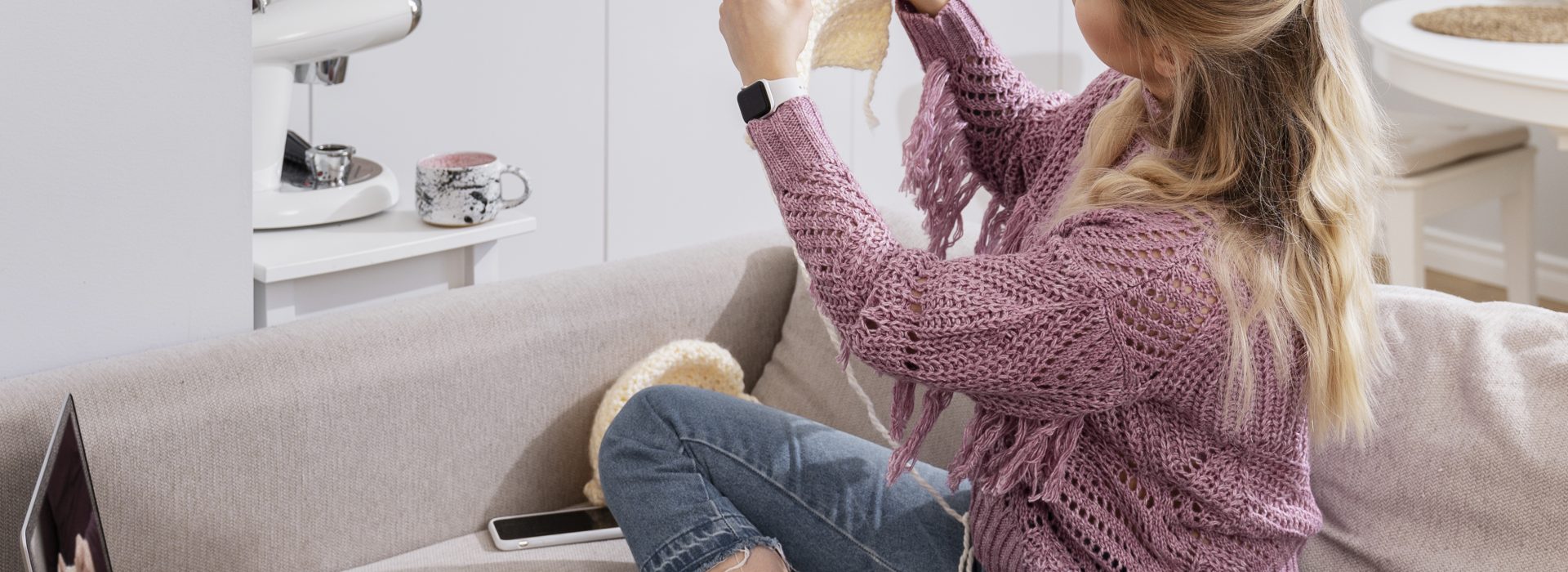 Young woman knitting while relaxing